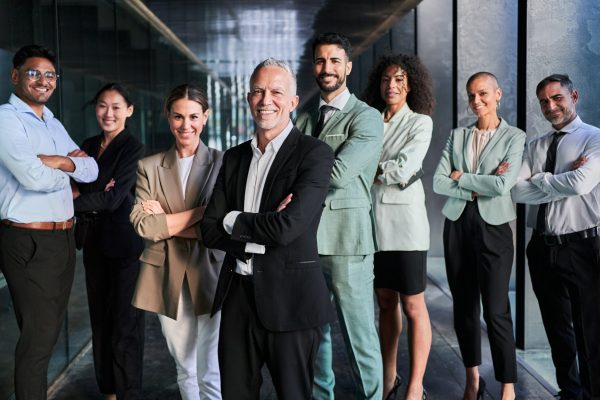 Multicultural business team headed by boss. Posing to camera cheerfully at the office. Multicultural business team headed by boss. Posing to camera cheerfully at the office.